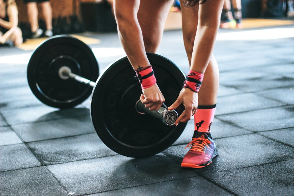 Athlete tightening barbell plates in a gym, emphasizing fitness and strength