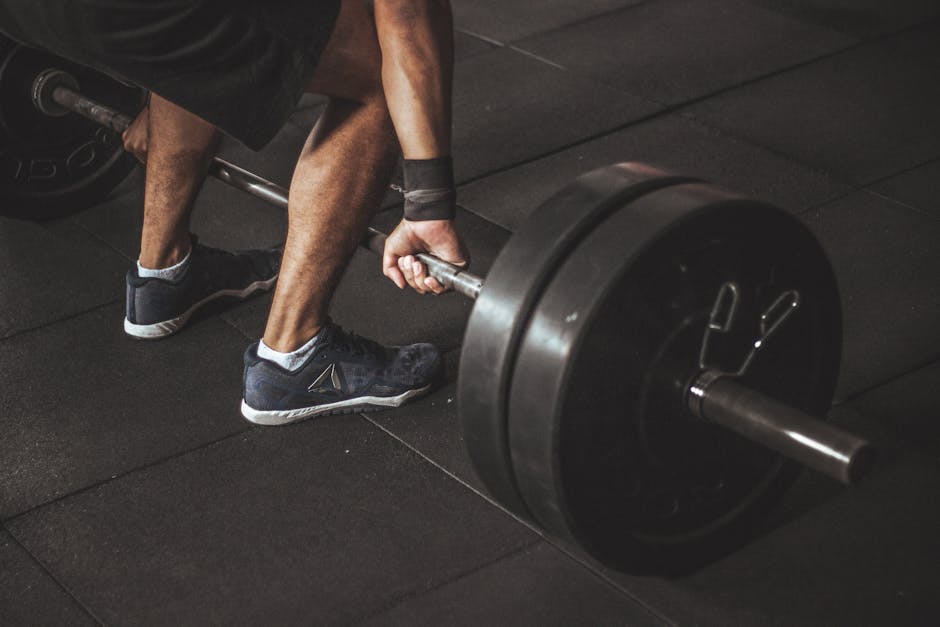 A man lifting a heavy barbell during a gym workout, showcasing strength and fitness